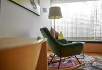 a living room with a green chair and a table at Bonawinkel NEU in Gaschurn