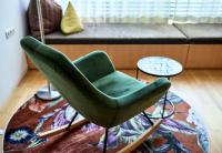 a green chair in a living room with a couch at Bonawinkel NEU in Gaschurn