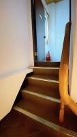 a room with stairs with a chair and a window at Sun B&amp;B in Taitung City
