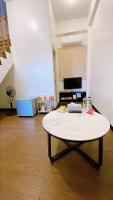 a white table with a laptop on it in a room at Sun B&amp;B in Taitung City