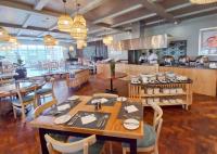 a dining room with tables and chairs and a restaurant at Blue Marlin All-Inclusive Seascape by Dream Resorts in Scottburgh