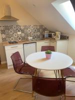 a kitchen with a white table and chairs at Amaryllis aux Bords de Loire in Les Rosiers