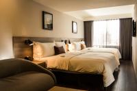 a hotel room with two beds and a window at Just Sleep Kaohsiung Zhongzheng in Kaohsiung