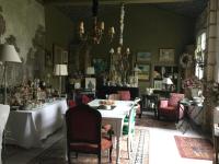 a dining room with a table and chairs at L’orangerie du Général in Saint-Jean-dʼAngély