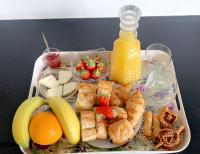 a tray of food with a plate of food with fruit at Gîte Riad 4 personnes in Narbonne