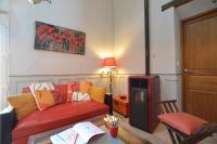 a living room with a red couch and a table at La porcherie du pet en l&#39;air in Saint Malo