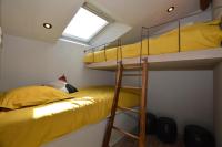 a bedroom with two bunk beds and a window at La porcherie du pet en l&#39;air in Saint Malo