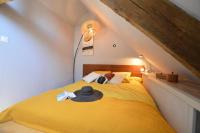 a bedroom with a yellow bed in a attic at La porcherie du pet en l&#39;air in Saint Malo