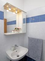 a bathroom with a sink and a mirror and a towel at Apartmani Krmek in Mlini