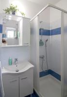 a bathroom with a sink and a shower at Apartmani Krmek in Mlini