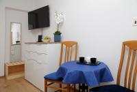 a kitchen with a table with a blue table cloth at Apartmani Krmek in Mlini