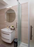 a bathroom with a sink and a mirror at Apartmani Krmek in Mlini