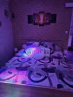 a bedroom with a purple bed with a purple light at Chambres d&#39;hôtes avec jacuzzi privatif in Westrehem