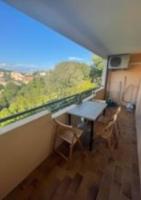 a room with a table and chairs and a large window at Studio with large balcony and nice view by Weekome in Vallauris