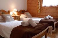 a bedroom with two beds with stuffed animals on them at Chataigne, cosy 3 bedroom apartment with great views in Sainte-Foy-Tarentaise