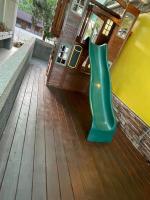a green slide sitting on a wooden deck at Sansendai Sea View B&amp;B in Chenggong