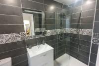 a bathroom with a sink and a shower and a toilet at Studio palais de justice in Rouen