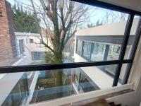 a view from a window of a house with a tree at Maginifique villa d&#39;architecte sur les bords de Marne tout près de Paris in Le Perreux-Sur-Marne