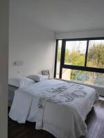 a bedroom with a bed and a large window at Maginifique villa d&#39;architecte sur les bords de Marne tout près de Paris in Le Perreux-Sur-Marne