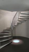 a metal staircase with a light in the middle at Maginifique villa d&#39;architecte sur les bords de Marne tout près de Paris in Le Perreux-Sur-Marne
