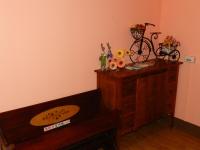 a wooden dresser with a bike on top of it at Home in Hengchun Homestay in Hengchun South Gate