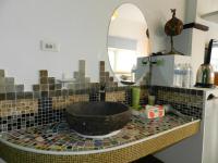 a bathroom with a black sink and a mirror at Home in Hengchun Homestay in Hengchun South Gate