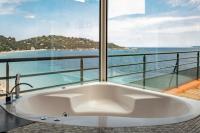 a bath tub with a view of the ocean at Surplage Hotel Cavalière in Le Lavandou