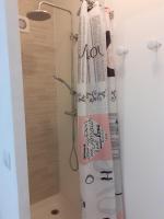 a shower curtain is hanging in a bathroom at F1 proche mer in Saint-Nazaire