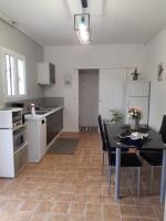 a kitchen and dining room with a table and chairs at F1 proche mer in Saint-Nazaire