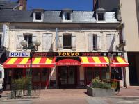 a hotel with a red and yellow awning on a building at Hotel Restaurant Tokyo in Trouville-sur-Mer