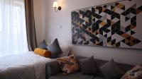 a living room with a bed and a couch at El Hogar near UN Headquarters, Gigiri in Kiambu