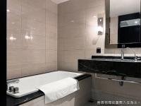 a bathroom with a bath tub and a sink at Talmud Hotel Kaohsiung LoveRiver in Kaohsiung