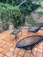two chairs and a table on a brick patio at La Villa de Niolon au coeur de la calanque vue mer in Le Rove