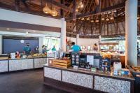 a restaurant with a counter with people preparing food at The Haven Khao Lak in Khao Lak