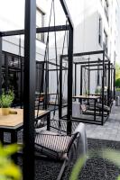a patio with benches and tables on a building at Art Suites Luxury Hotel in Kraków