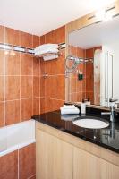 a bathroom with a sink and a mirror at Residhome Paris-Evry in Courcouronnes