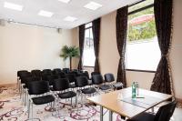 a meeting room with chairs and tables and windows at Residhome Paris-Evry in Courcouronnes