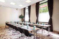 a row of tables and chairs in a room with windows at Residhome Paris-Evry in Courcouronnes