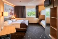 a hotel room with a bed and a desk at B&amp;B Hotel Heidelberg in Heidelberg