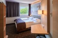 a hotel room with a bed and a desk at B&amp;B Hotel Heidelberg in Heidelberg