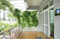 a patio with tables and chairs and a plant at 3520 Homestay in Taitung City
