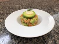 a white plate with a dish of food on a table at chambre d'hôtes Le Domaine de la Vallée in Saint-Martin-de-Varreville