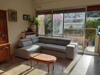 a living room with a couch and a coffee table at Nice Fabron 90 m2 avec Garage in Nice