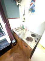 a small kitchen with a sink and a stove at Magnifique studio privé à Viljuif in Villejuif