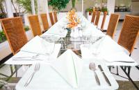 a long table with white napkins and silverware on it at Kantary Bay Hotel And Serviced Apartments Sriracha in Si Racha