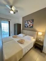A bed or beds in a room at Koumaros Aparthotel