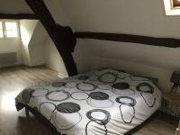 a bed in a room with at Bel appartement dans petite citée de caractère in Tréguier
