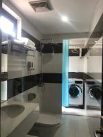 a bathroom with a sink and a washing machine at New Tourane Hotel in Danang