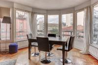 a room with a desk and chairs and windows at Le Charlemagne- Boulogne in Boulogne-Billancourt
