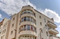 a tall white building with windows on top of it at Le Charlemagne- Boulogne in Boulogne-Billancourt